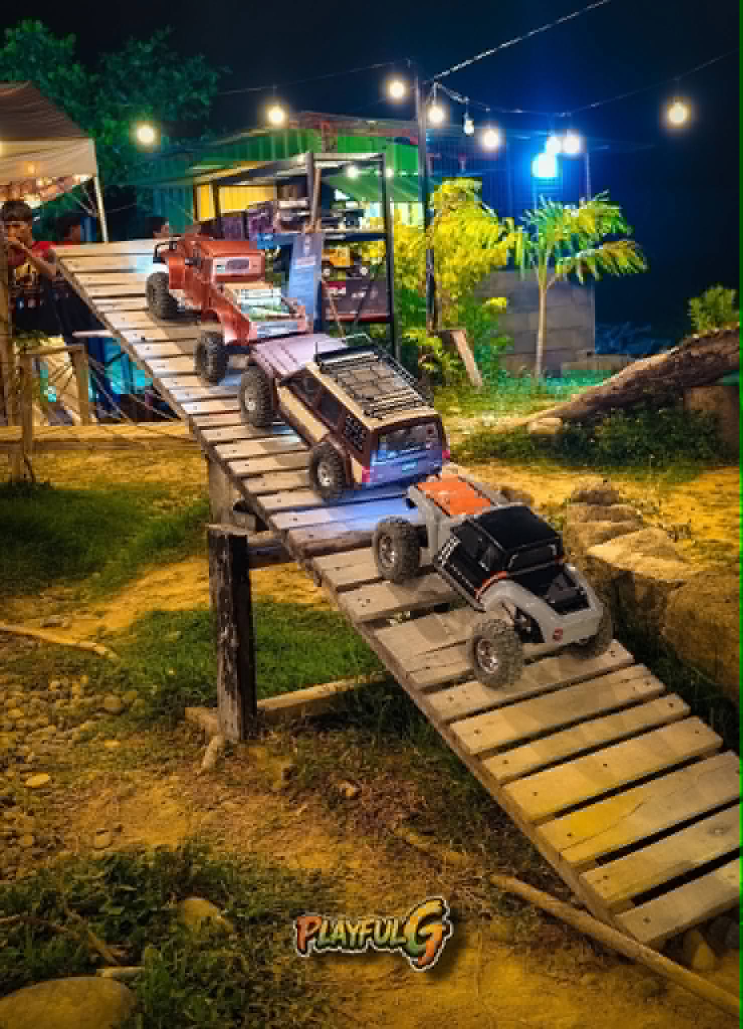 RC crawlers on wooden plank ramp at Mudace RC Park