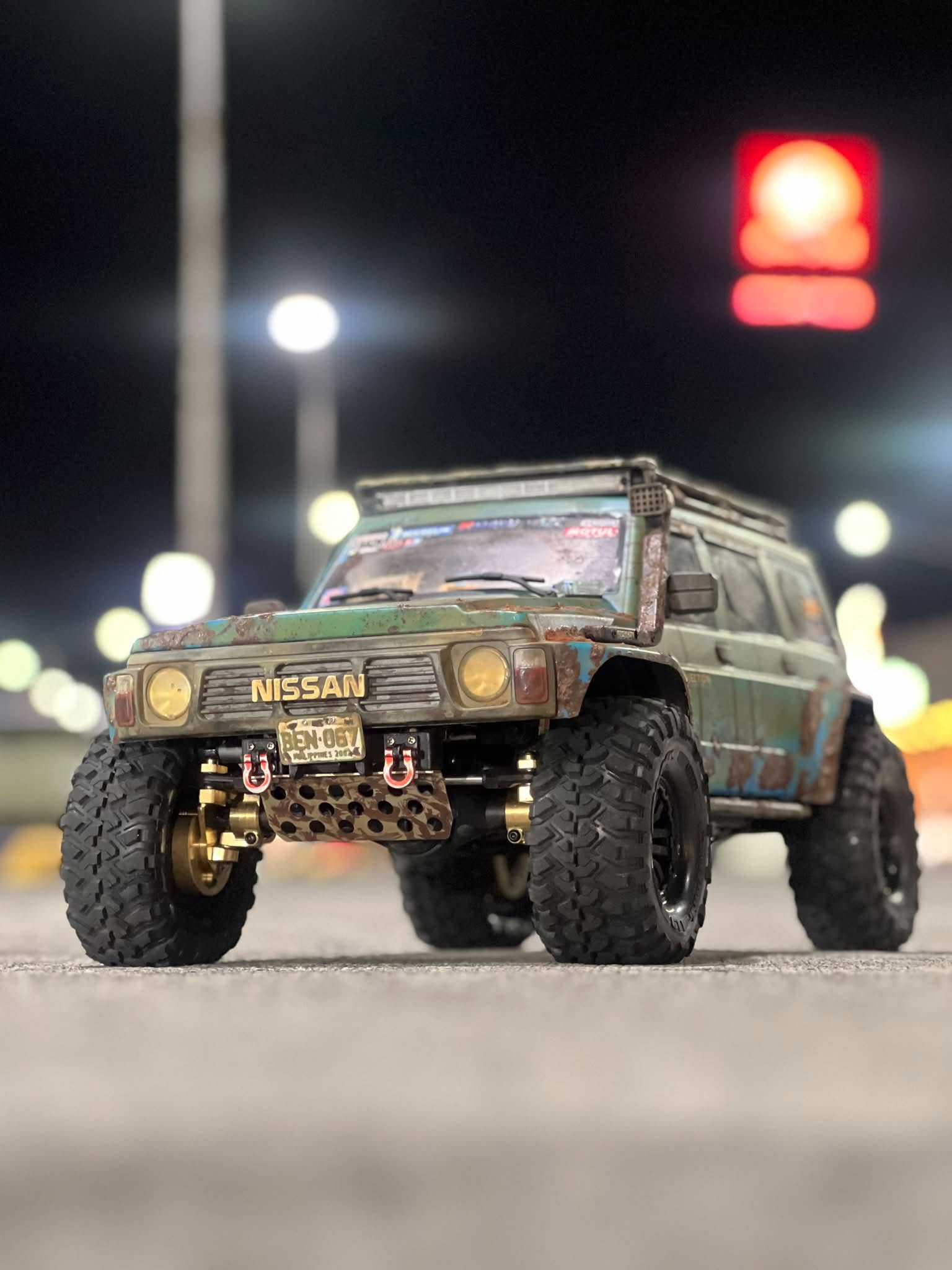 Raven Gamotioa personal 1/10 scale Nissan Patrol RC crawler with brass upgrades and Filipino license plate detail BEN-067 photographed at night on the road
